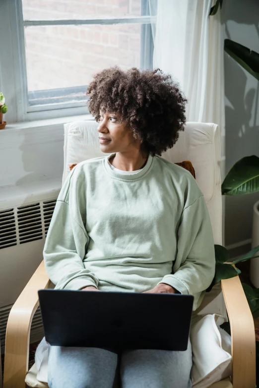 a person in a chair with a laptop