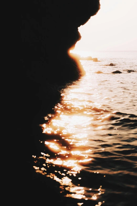 a person sitting on a bench next to the water