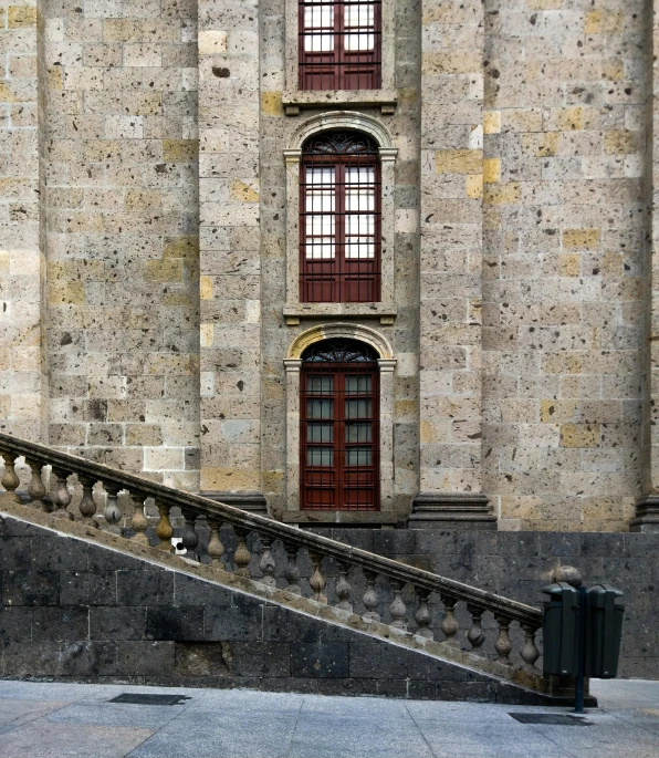 stairs lead up to a balcony with an open door and window