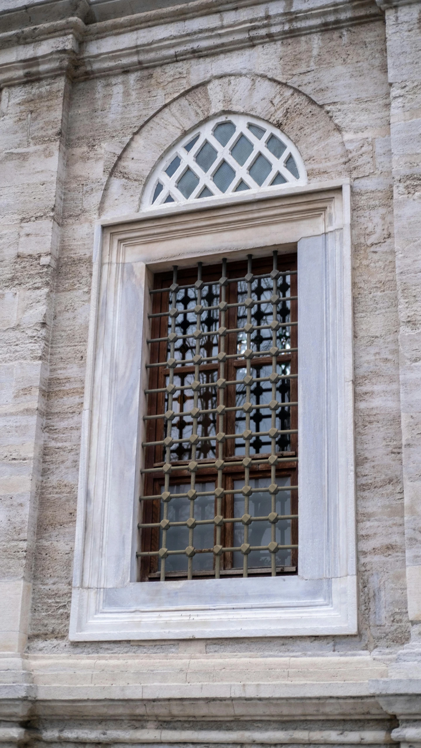 a brick building with a window and bars