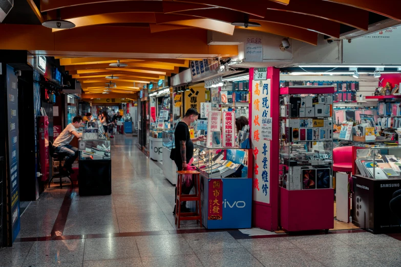 a couple of men in store with some electronic equipment