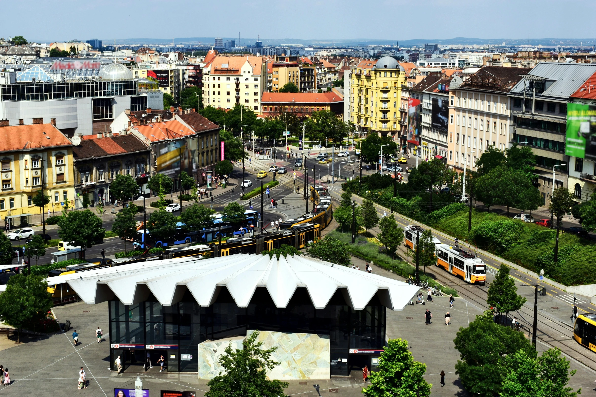 a wide view of buildings with roofs covered by awnings