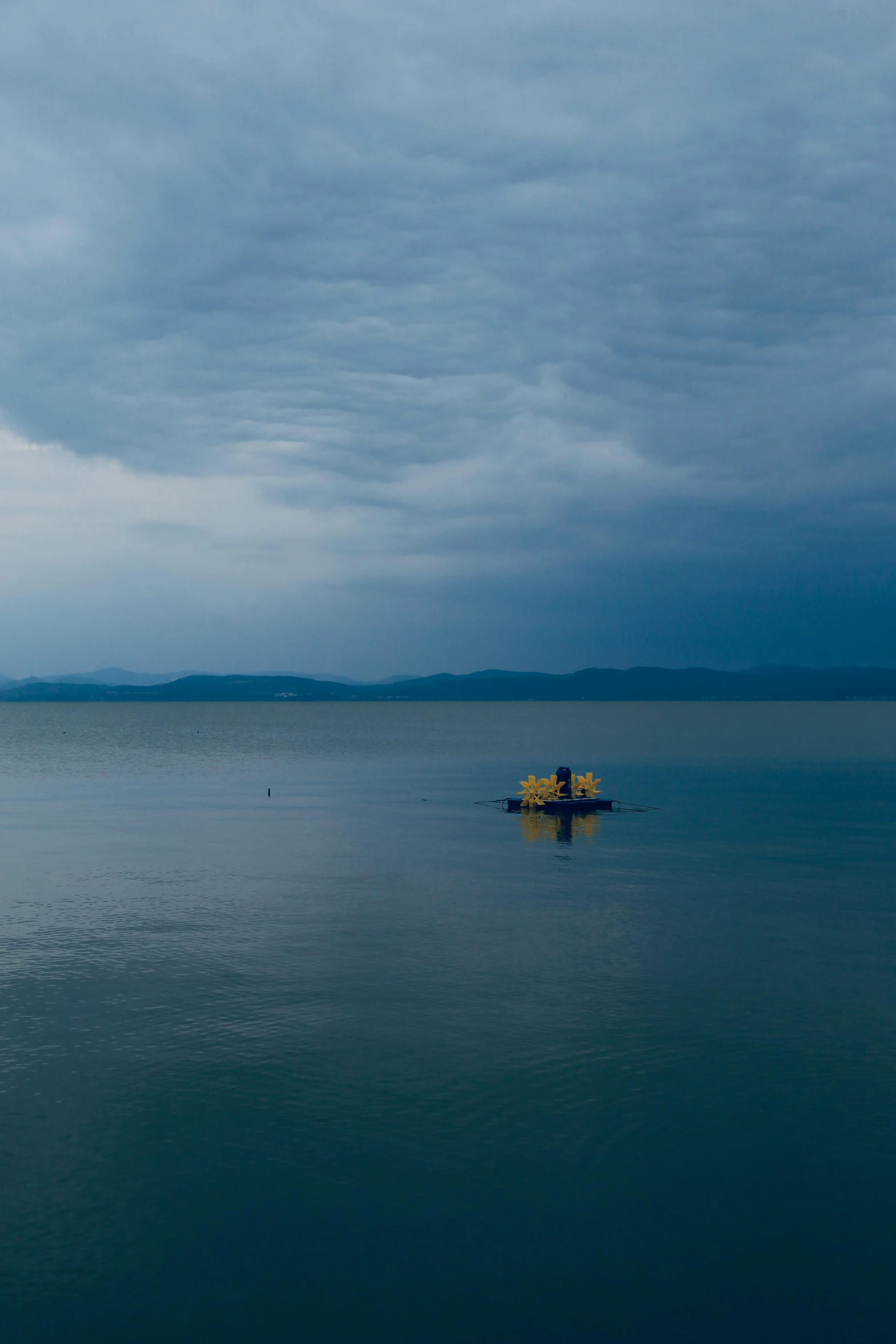 the ocean is clean and peaceful, with boats out on it