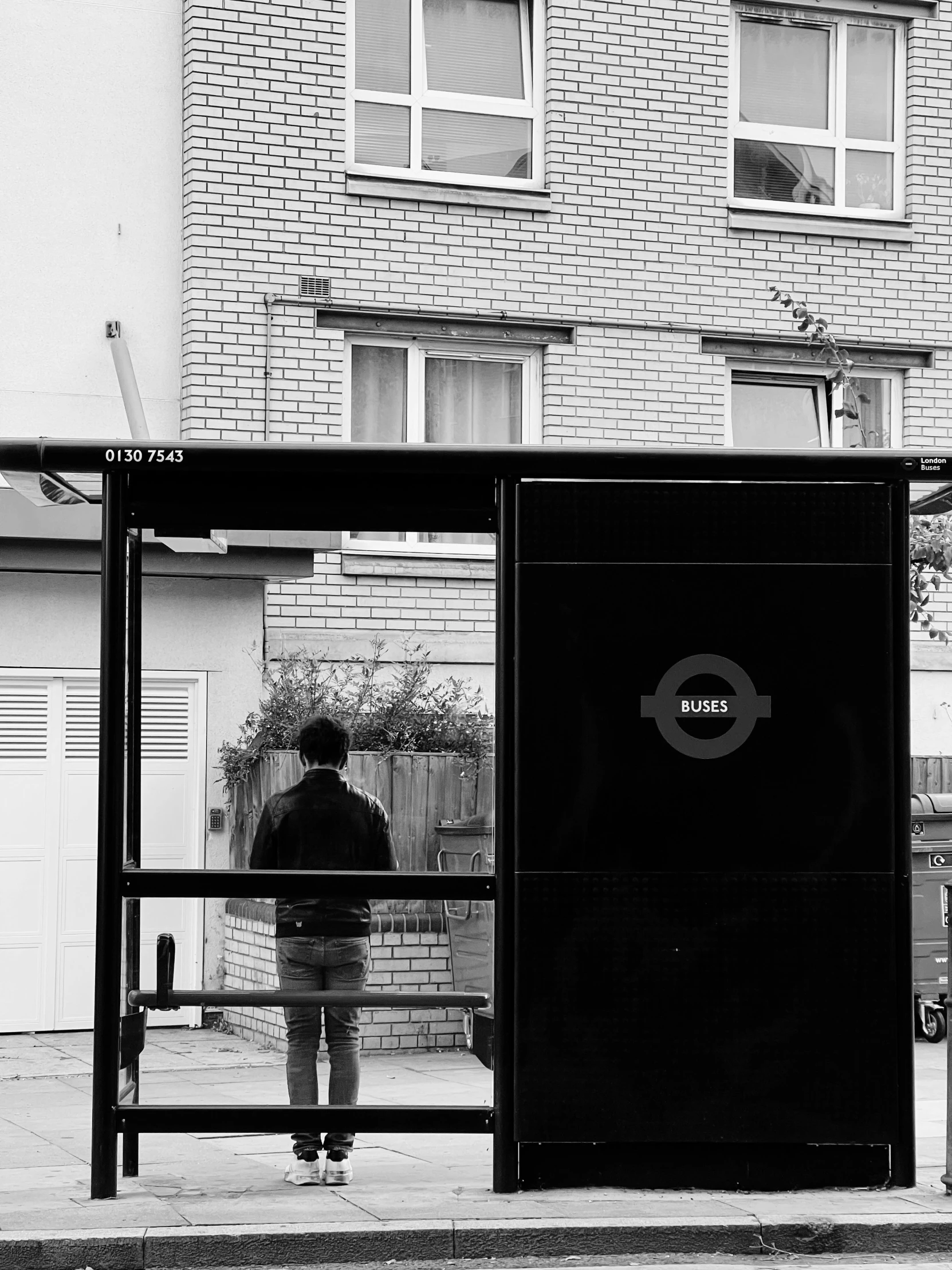 a person sitting on a bench in front of a train