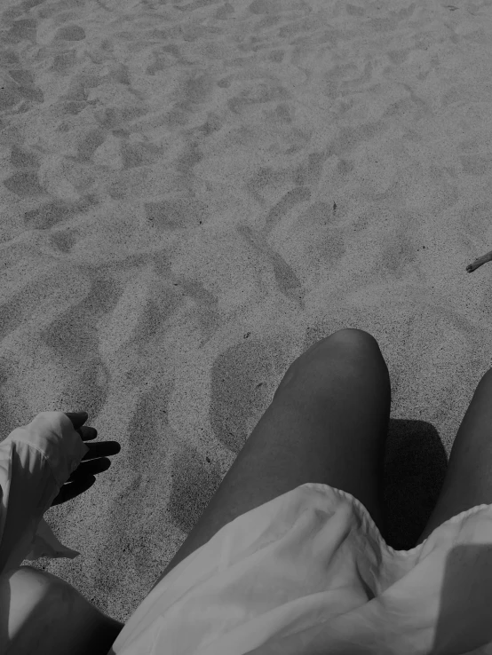 a person on a beach is holding a cellphone