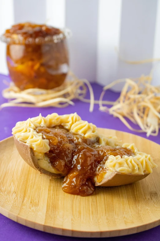 the baked food is sitting on a wooden tray