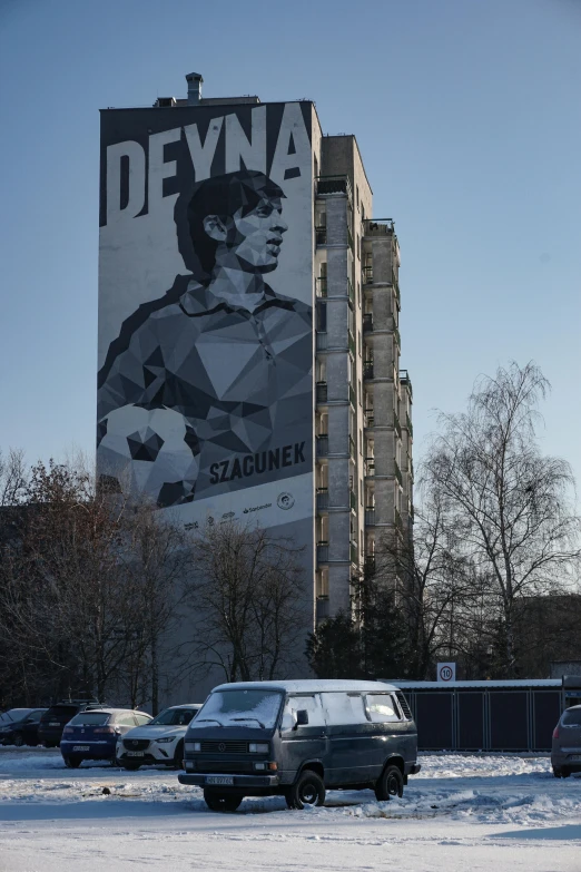 a huge poster on the side of a building depicting batman