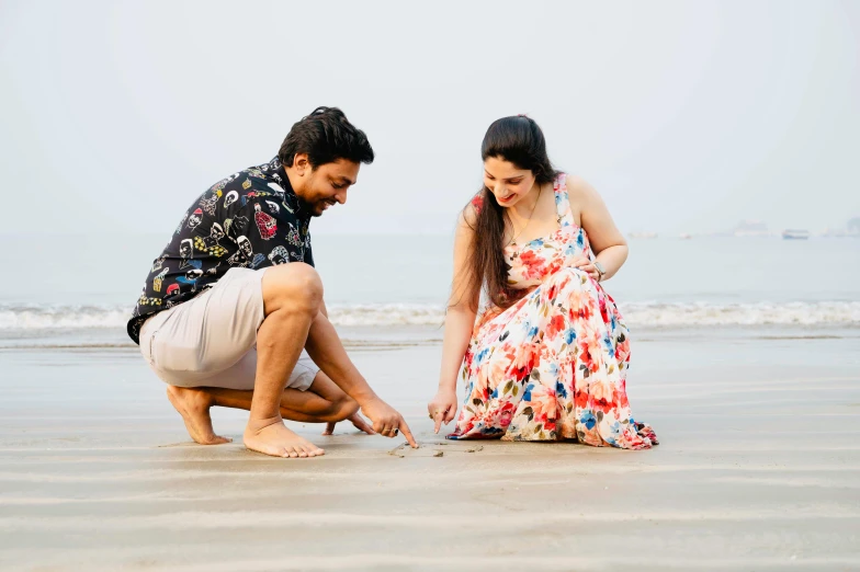 an image of two people playing in the sand