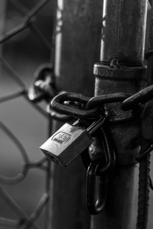 a chain link fence with an old padlock