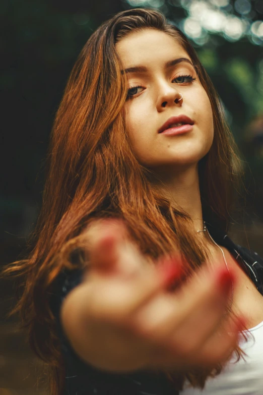 a girl with red hands on her face