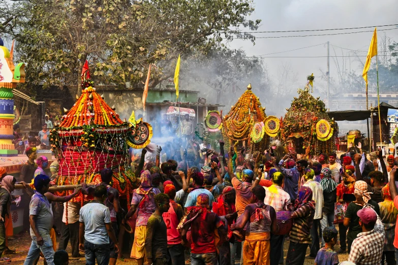 many people celeting indian festival with colored costumes