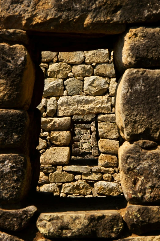 a doorway made out of stone near rocks