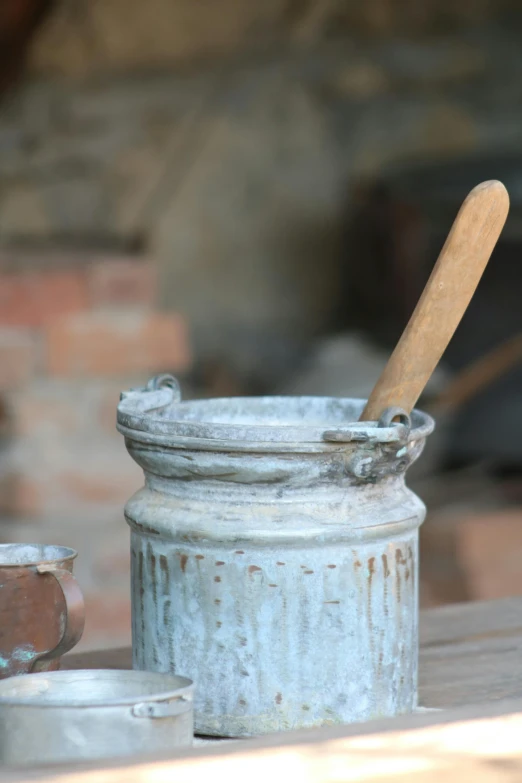 a wooden spoon rests in a tin container