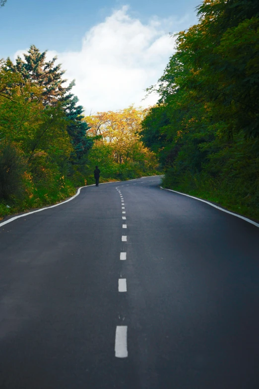 a person is riding on an empty road