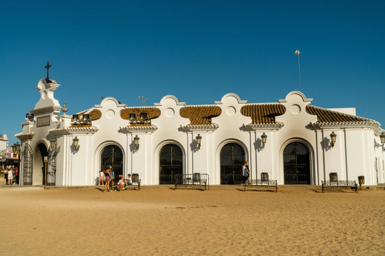 a large white building with decorative balconies and doors