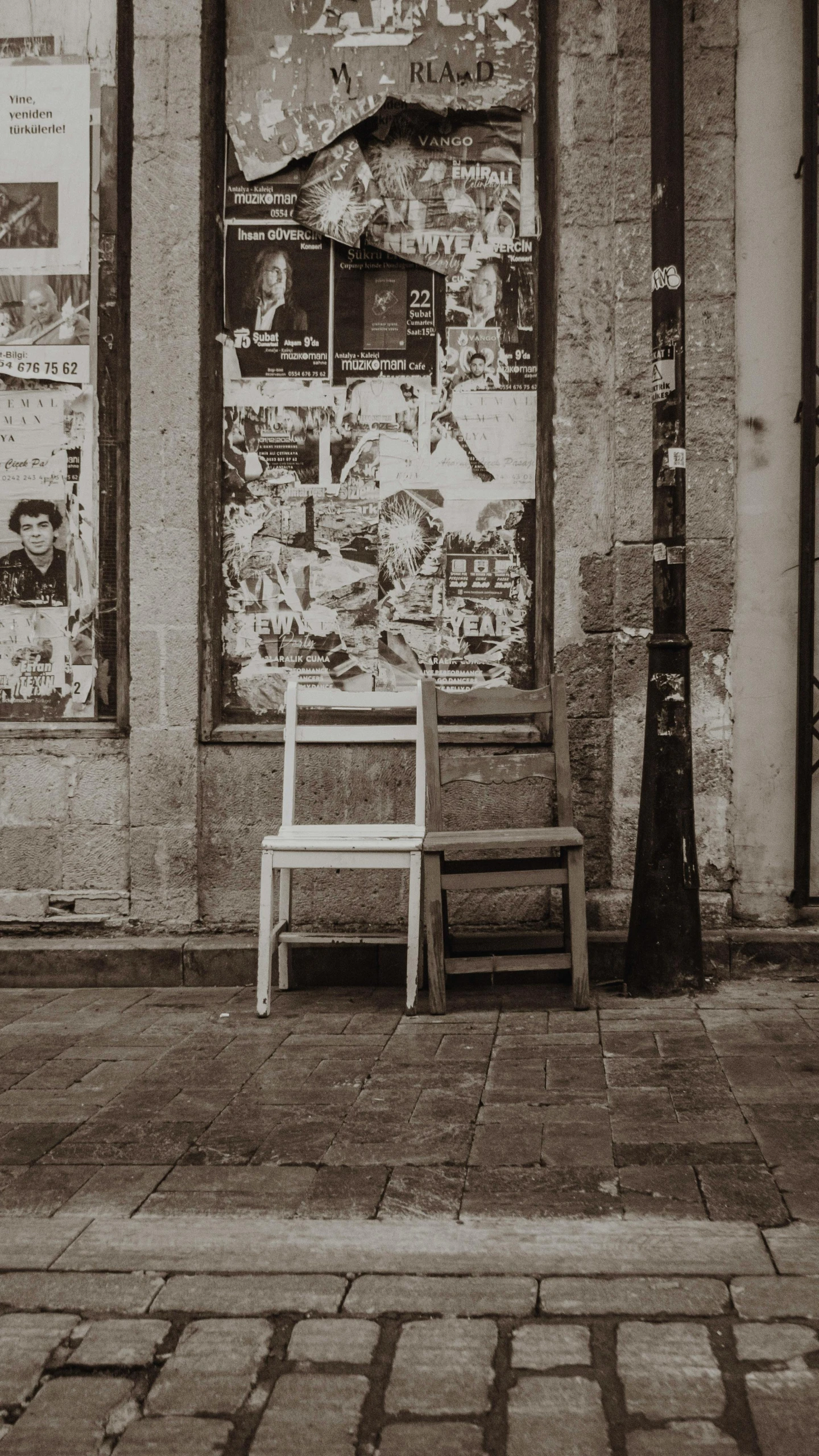 a lonely chair is sitting in front of an abandoned shop