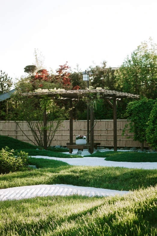 a patio with steps and bushes along it