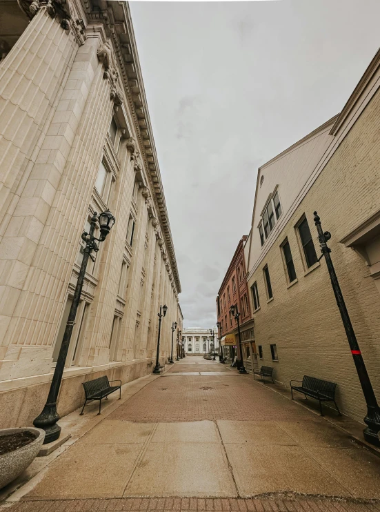 the empty street is very deserted under a cloudy sky