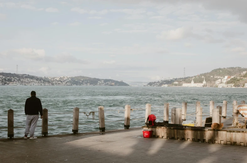 the man is looking out over the water from his dock