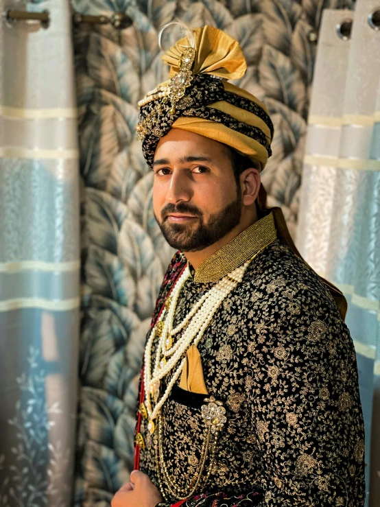 a man is dressed in a traditional indian outfit