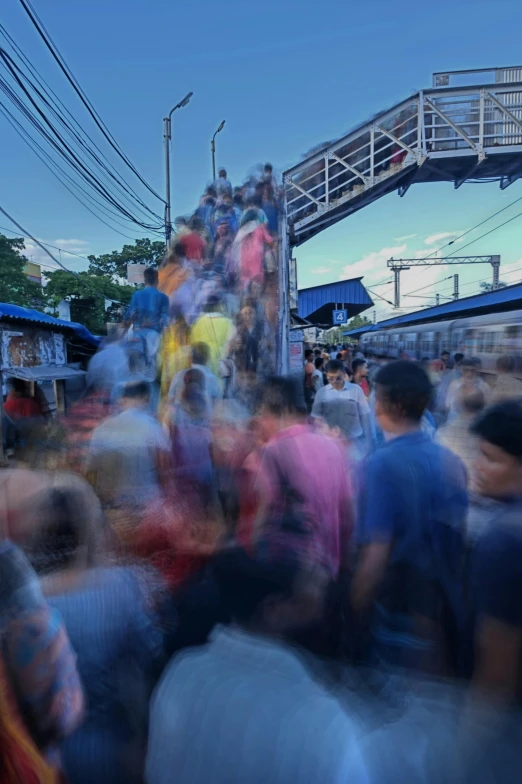 many people walking down the street, many carrying their luggage