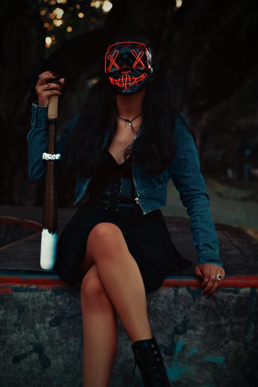 a woman sitting with a bat in her hand