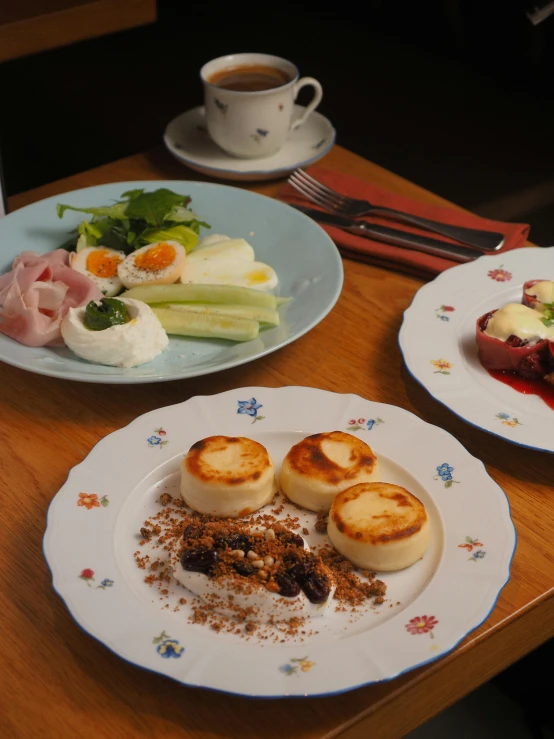 several plates with food on them, including meat and vegetables