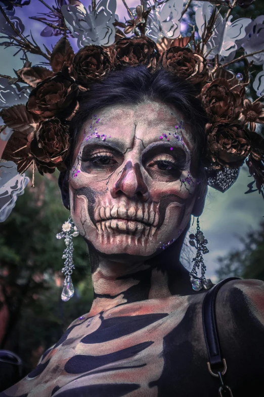 a woman with skeleton makeup and jewels in her hair