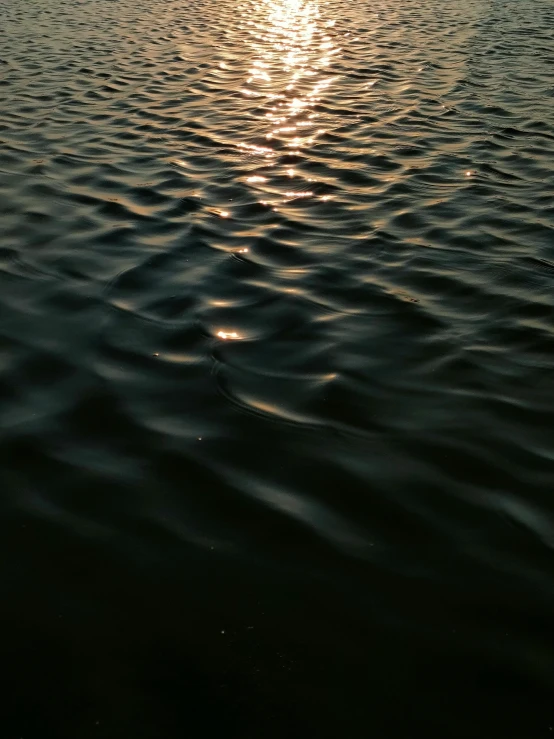 the sun shines brightly in the horizon as seen from the sea