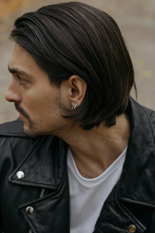 a close - up of a man wearing a leather jacket