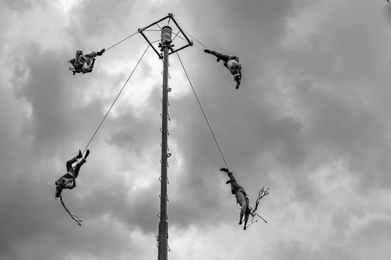 four people doing tricks on an obstacle course