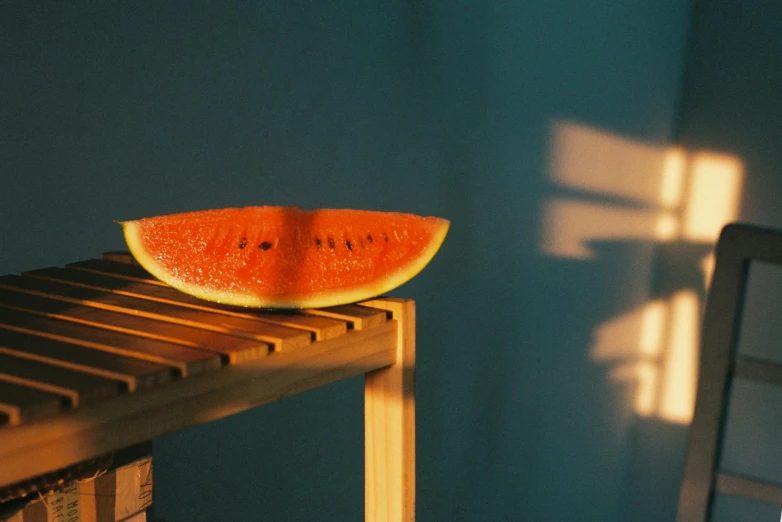 one piece of watermelon on the back of a chair
