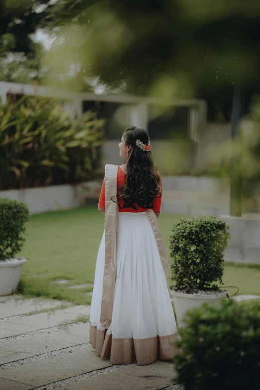 a bride wearing a white skirt and red top