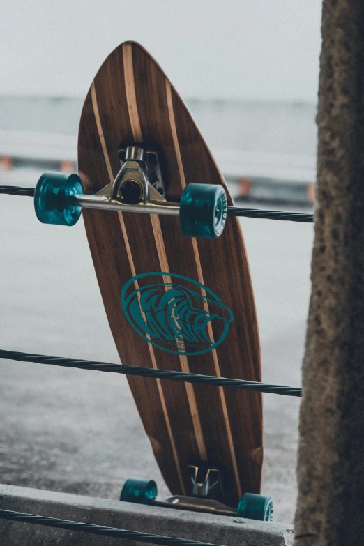a longboard is hanging on the rope of a pole