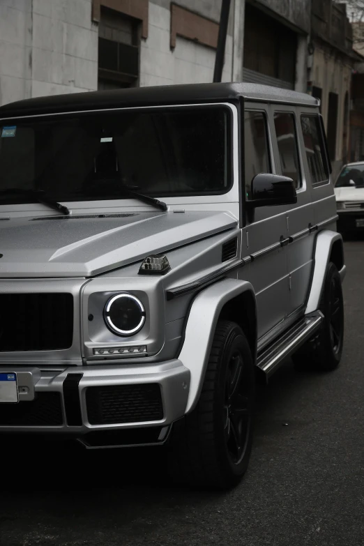 a mercedes benz g class is shown parked on a street