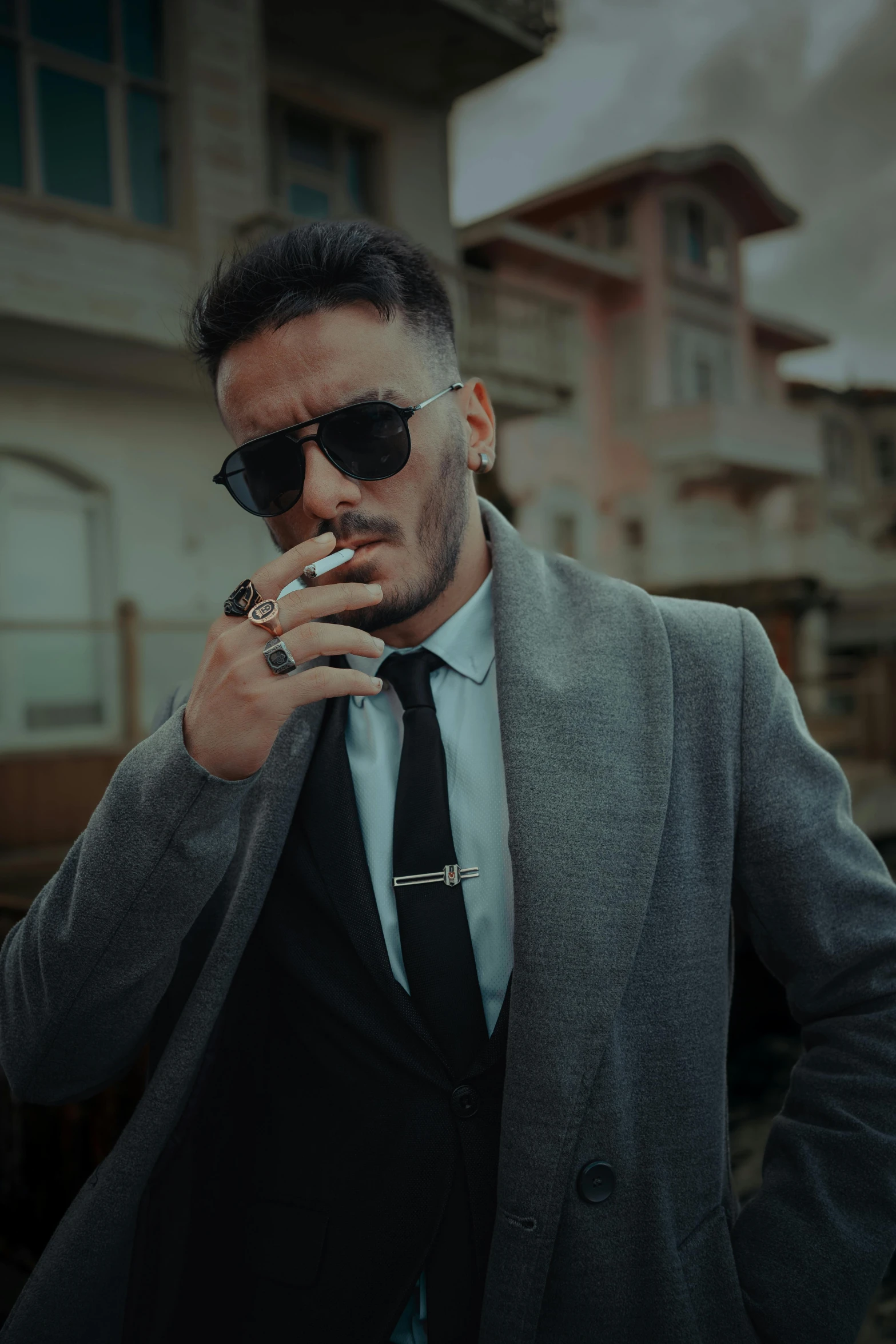 a man with sunglasses smokes his cigarette