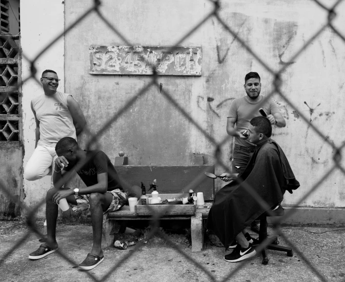 a group of people behind a chain linked fence