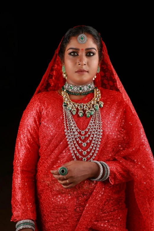 a indian woman is dressed in a red bridal