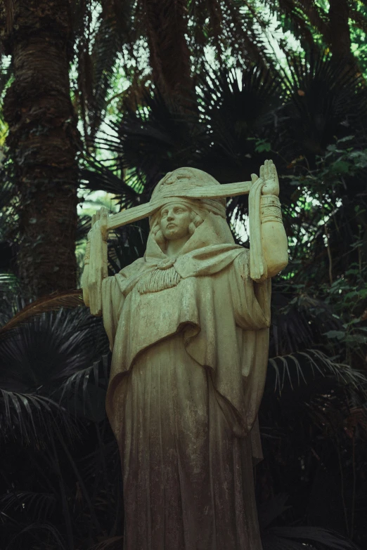 a statue in the shade holding a baseball bat