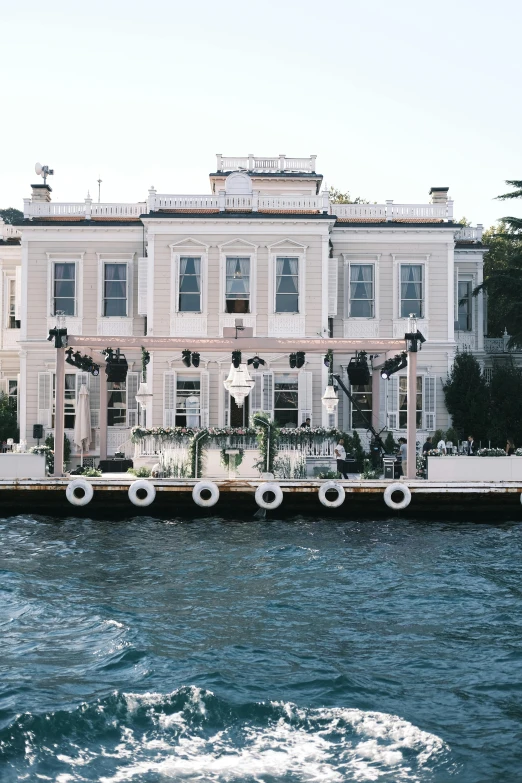a house with an open porch is shown across the water