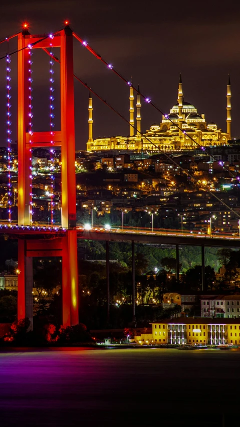 there is a picture of a bridge lit up at night