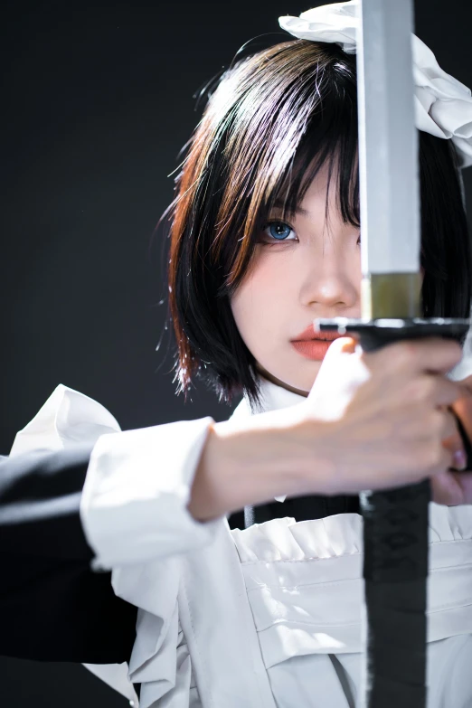a woman with black hair and blue eyes is holding a knife
