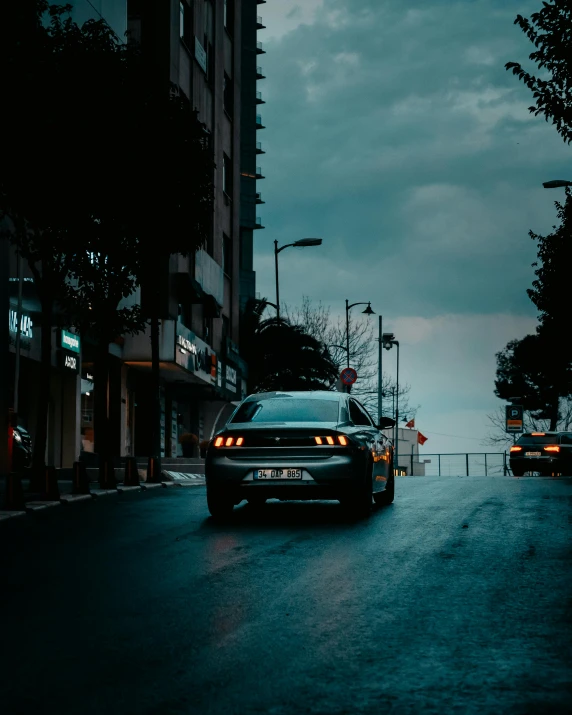 a night scene with a car and buildings