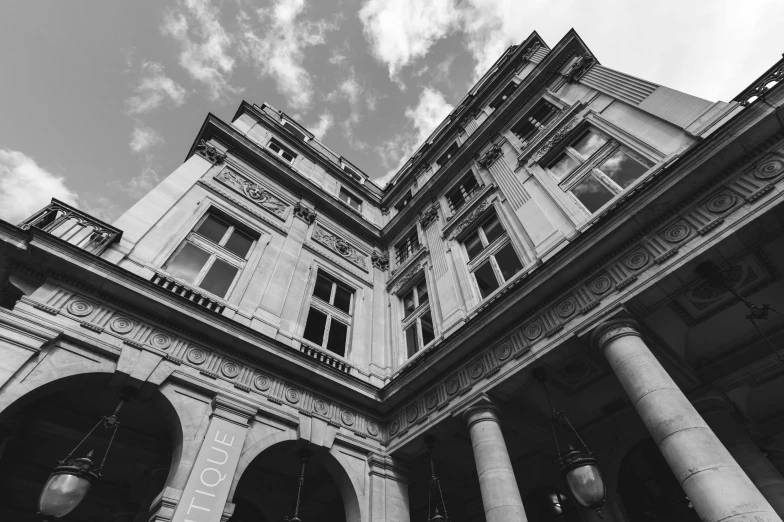 an architecturally ornate building with columns and pillars against a blue sky