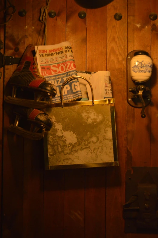 assorted items on a wooden table with a metal container below