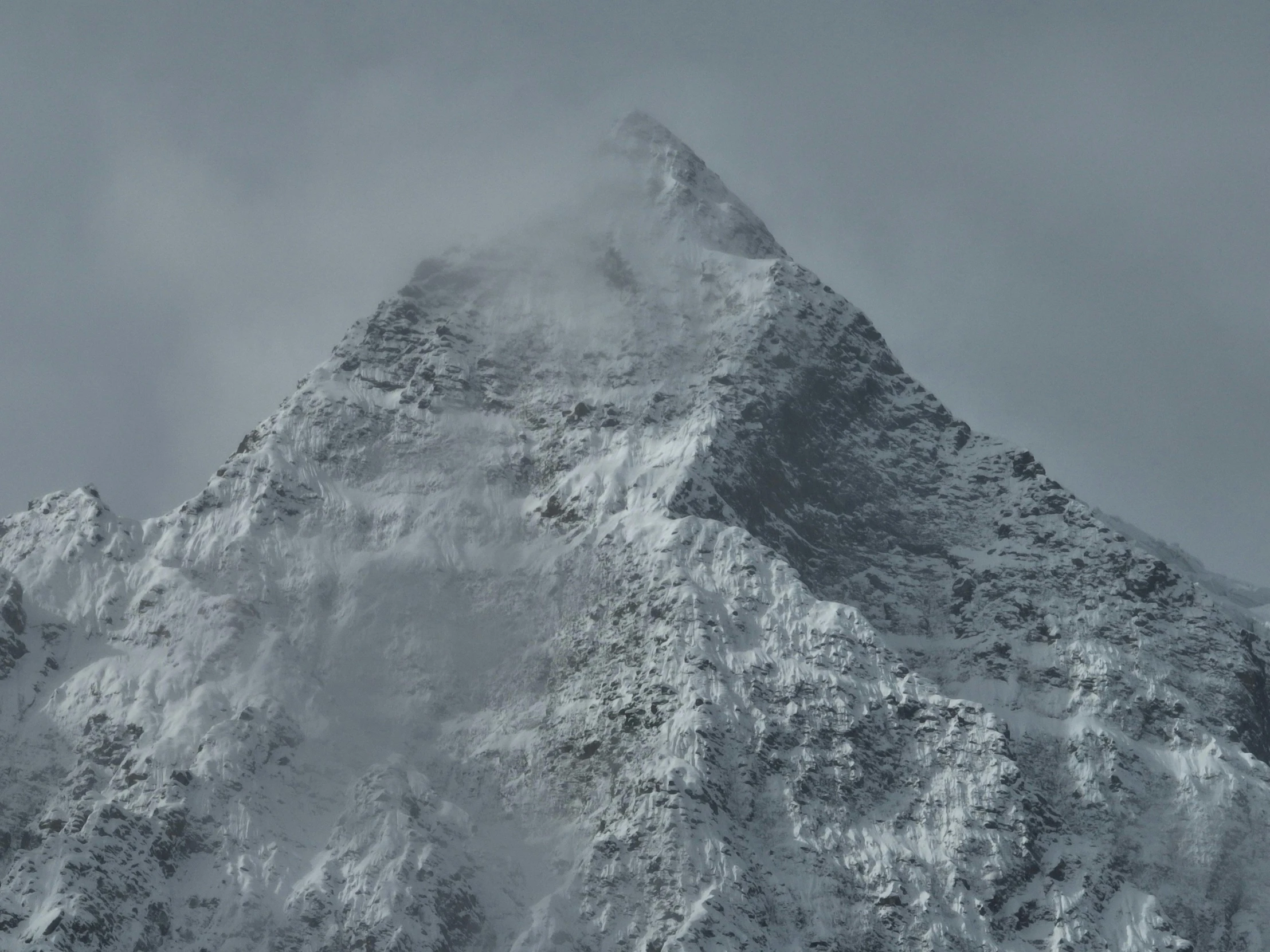 a very tall mountain that is covered in snow