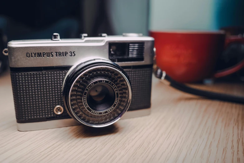 the camera is sitting on a wooden table