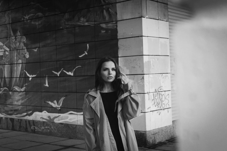 a woman in a jacket on the street posing