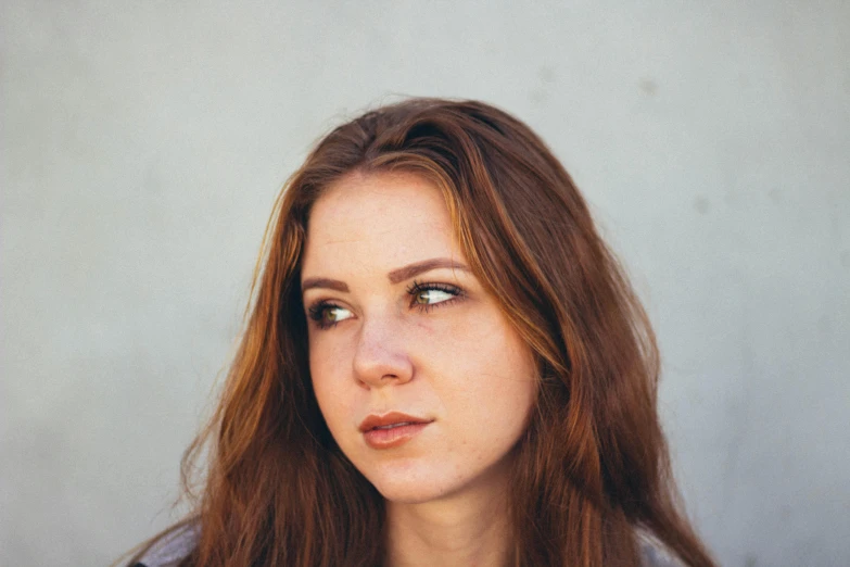 a woman is looking away with a serious look