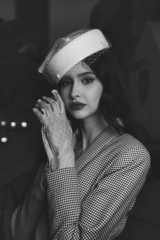 a woman holding her hand to her ear and looking at the camera